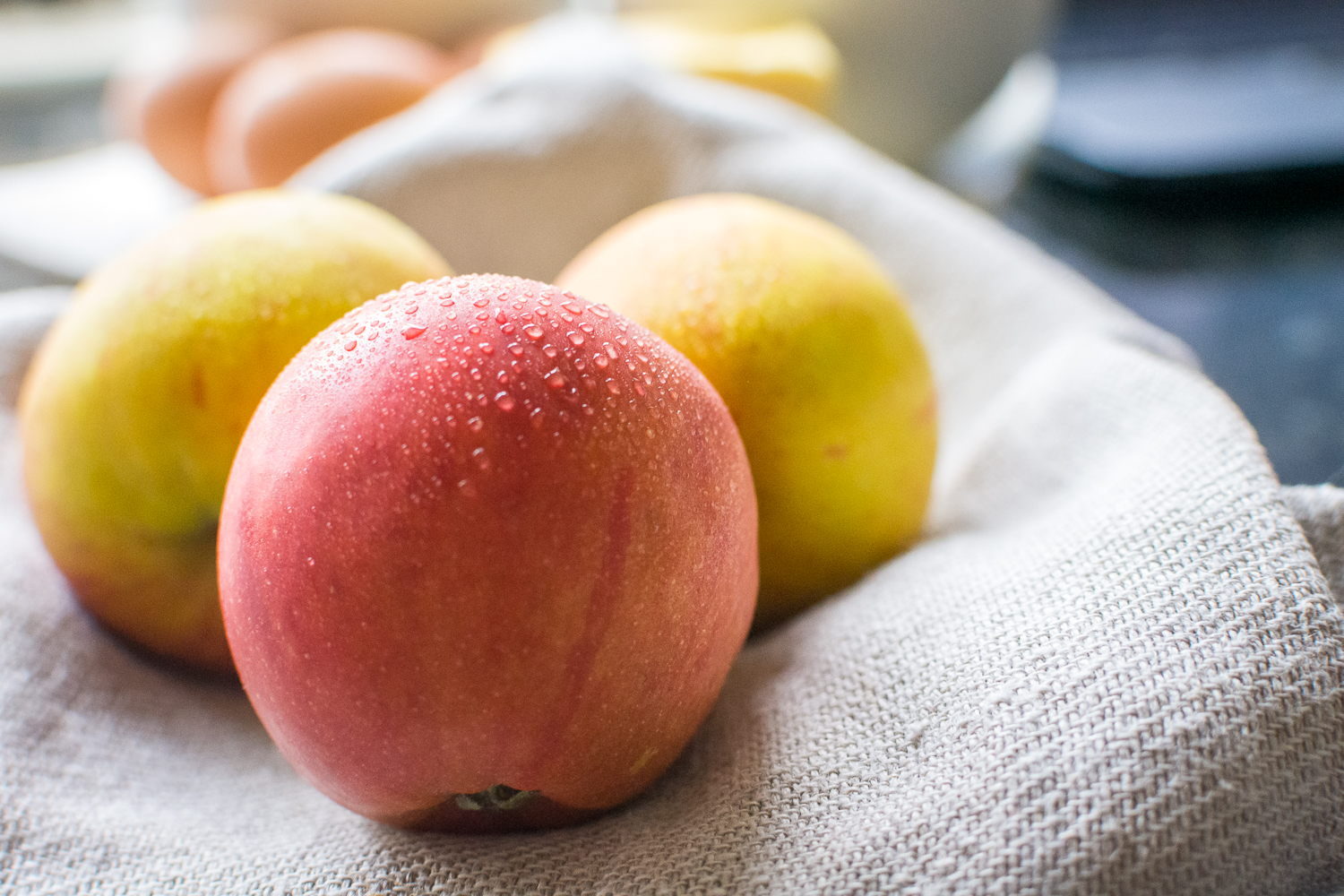Apples on a gray linen tea towel.