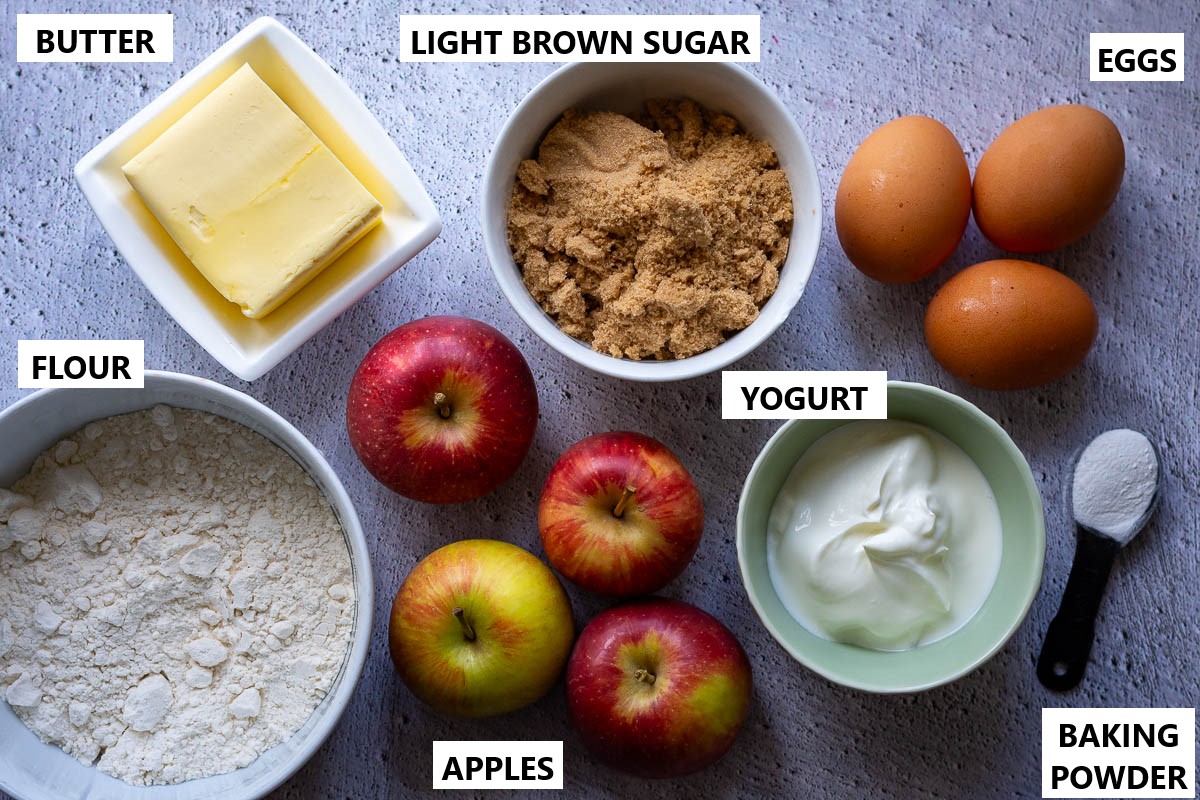 Ingredients for Lithuanian cake with apples on a grey surface.