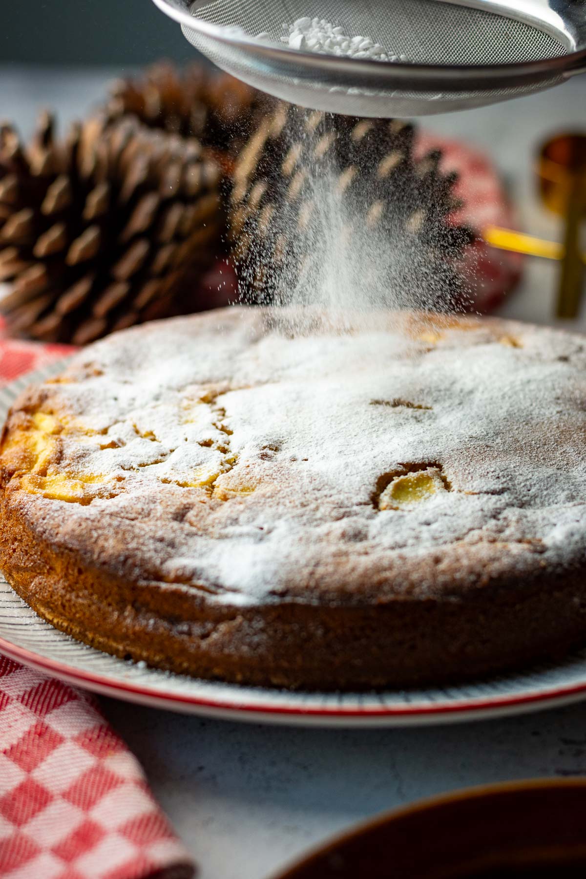 dusting apple cake with icing sugar.