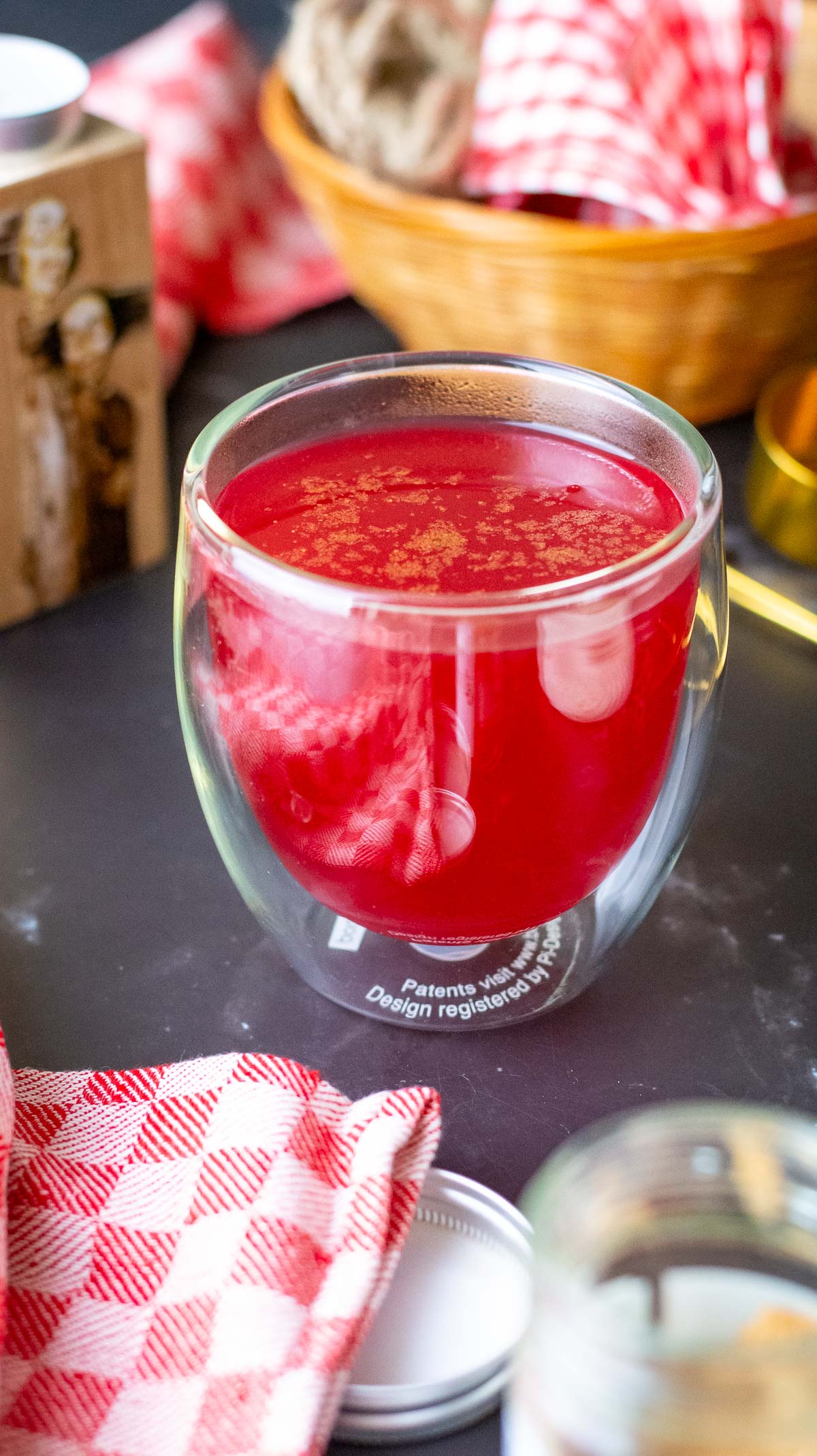 Cranberry Christmas drink with nutmeg on top.