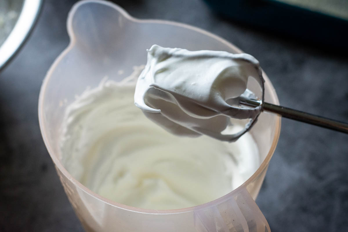 Medium stiff meringue wrapping around the mixer beater. 