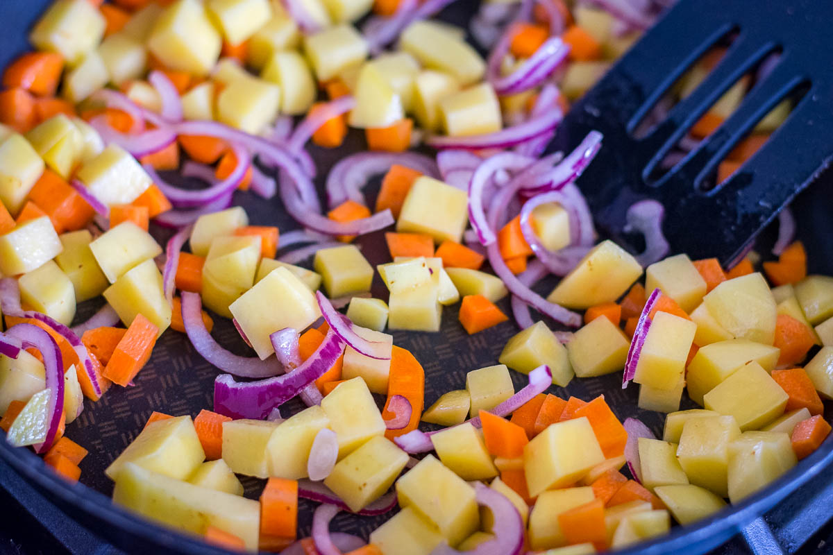 Vegetables sauteeing in the pan. 