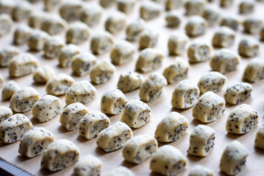 Small pieces of kuciukai on a parchment paper lined baking sheet.