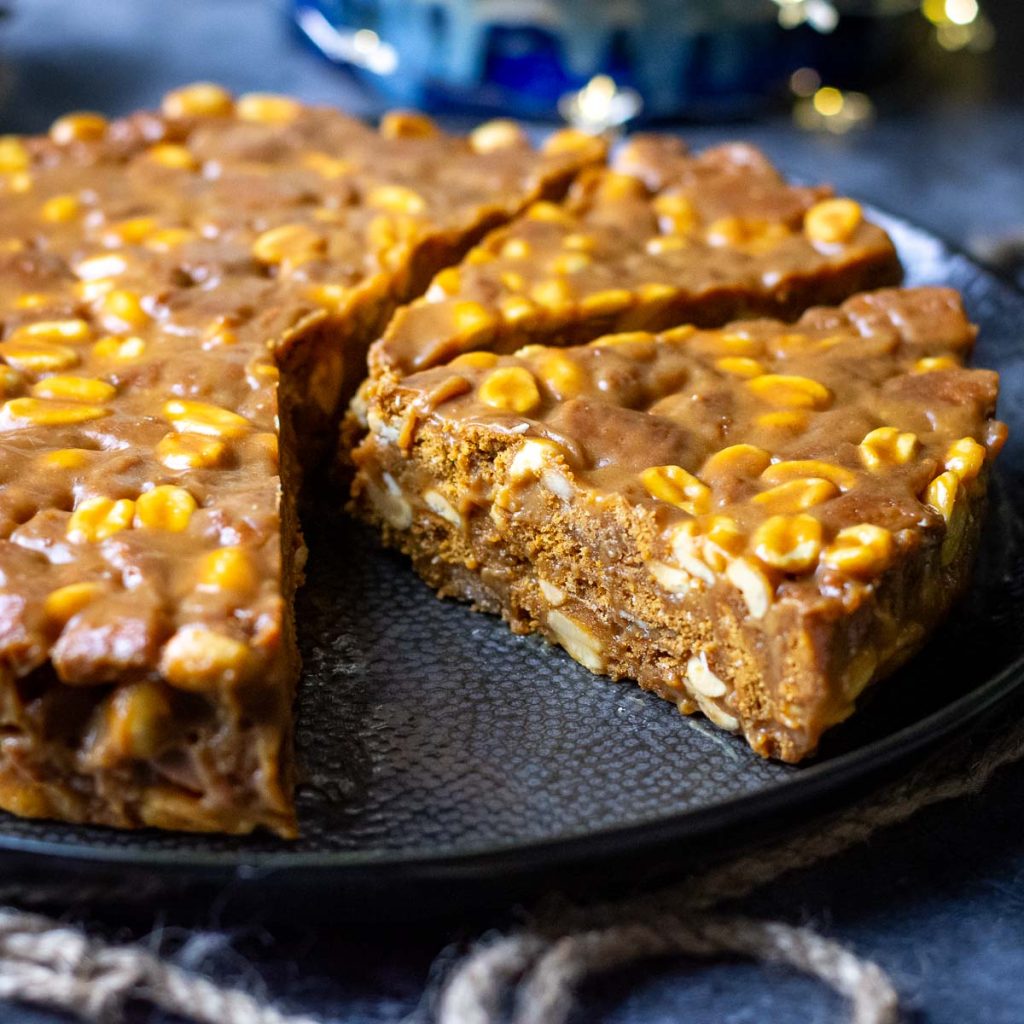 Lithuanian Caramel no-bake cake sliced on a large black plate.