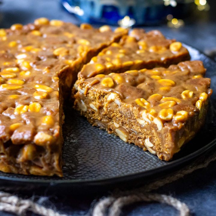 Lithuanian Caramel no-bake cake sliced on a large black plate.