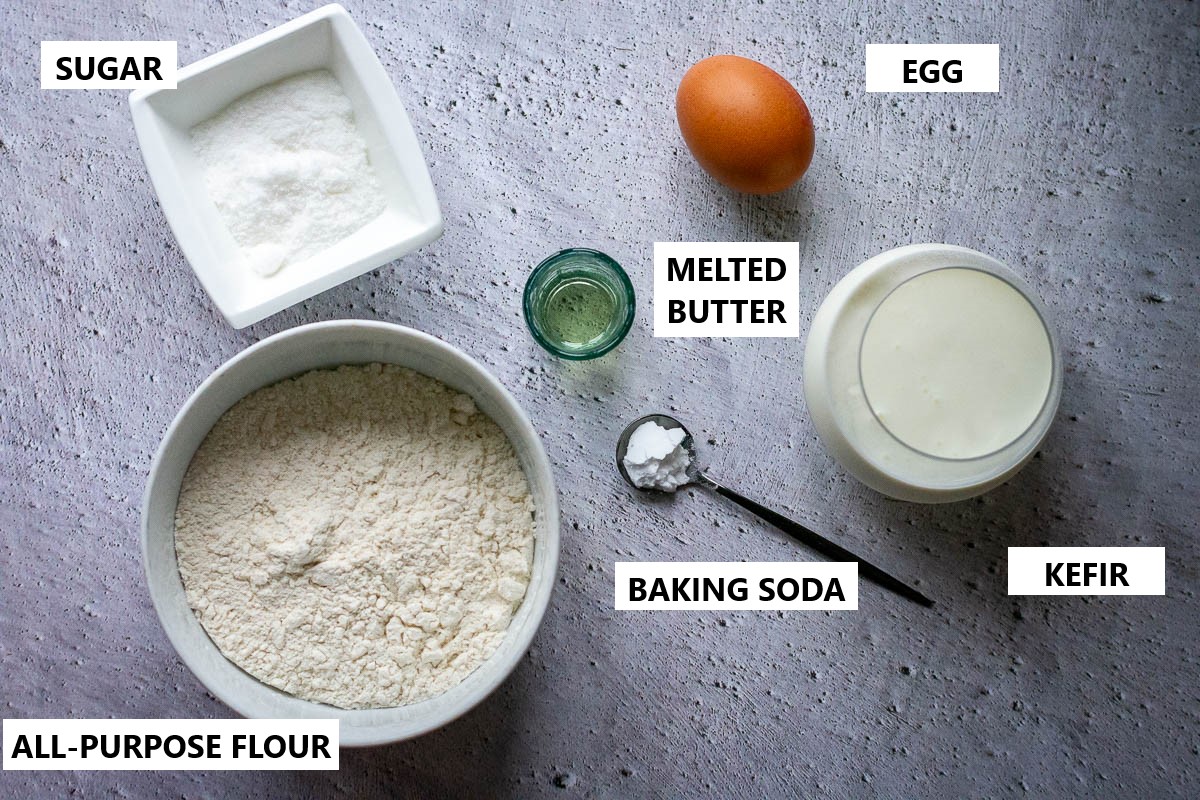 Ingredients for Lithuanian Pancakes with Kefir on a grey surface. 