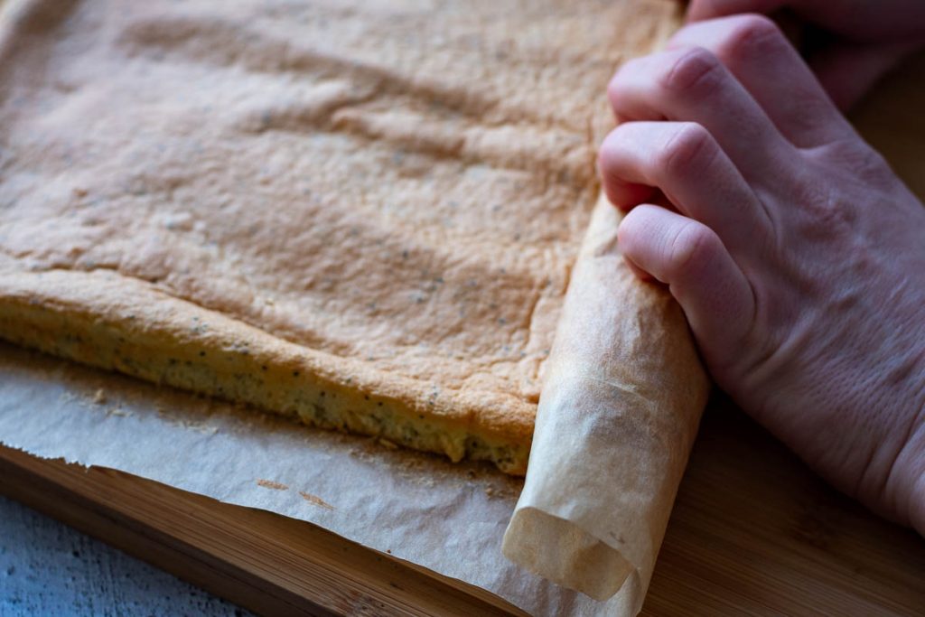 Rolling the sponge into a roll.