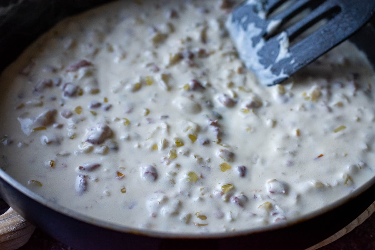 Reheating the Lithuanian sauce in a large frying pan. 