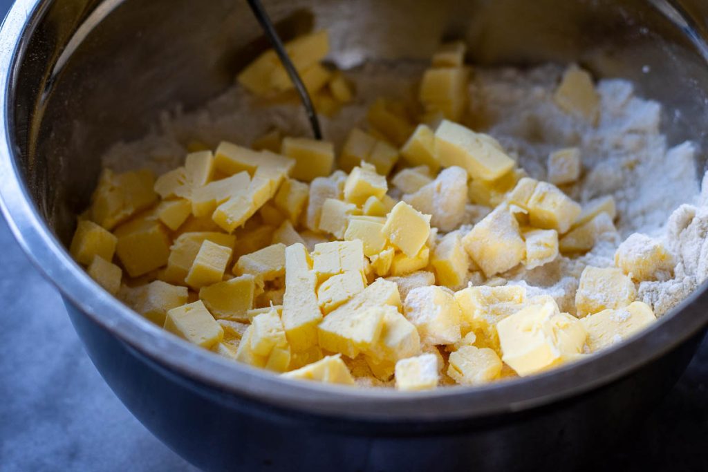 Cubed butter added to the dry ingredients. 