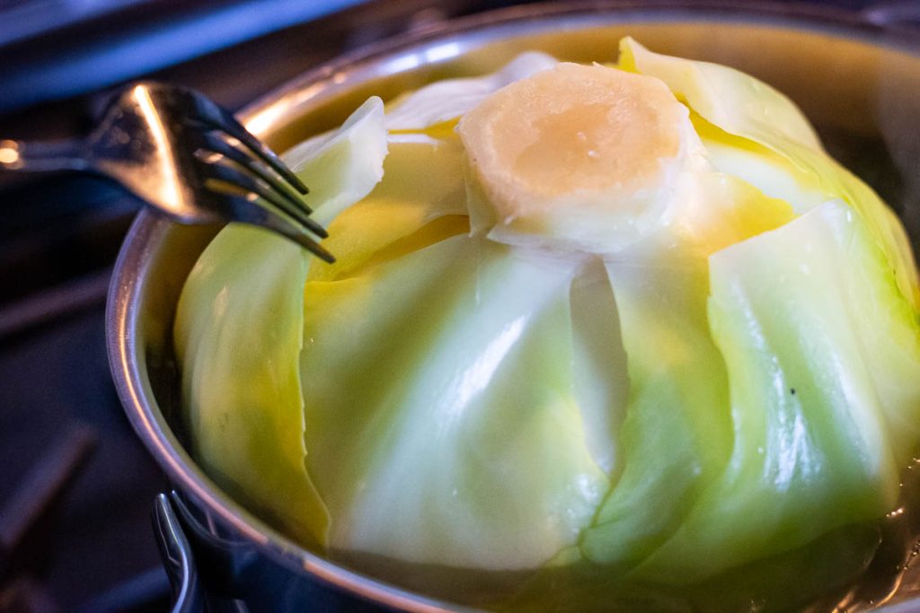 Taking off outer leaves that soften in boiling water to make LIthuanian Cabbage Rolls stuffed with pork. 