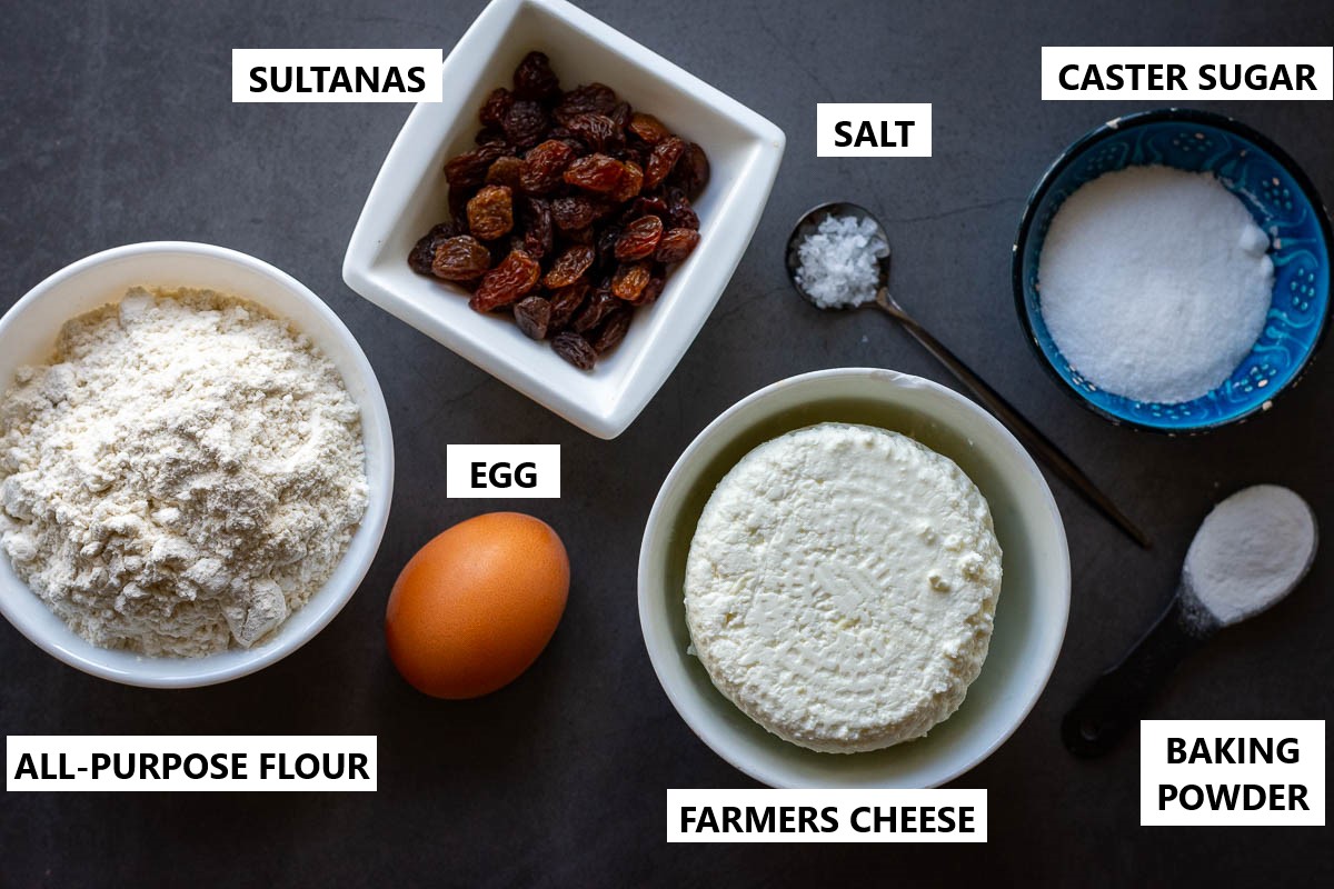 Ingredients for Lithuanian Farmers Cheese Pancakes on a grey surface. 