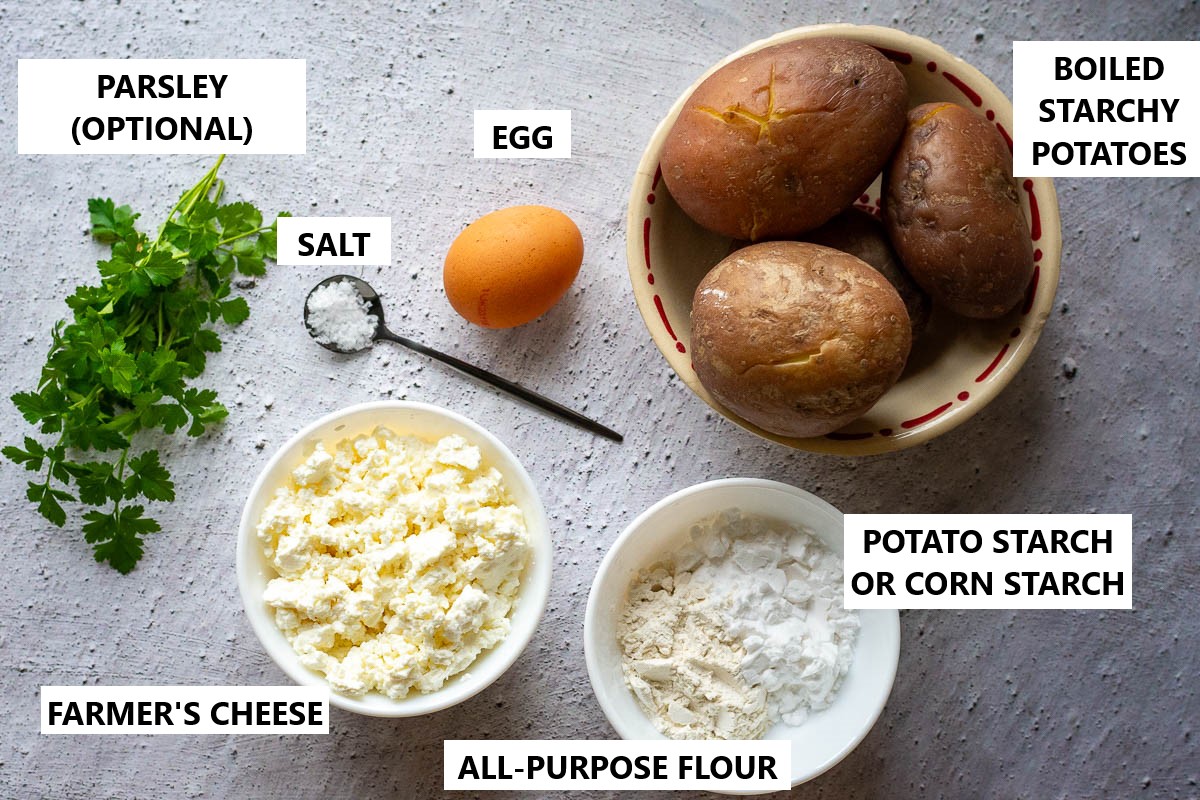 Ingredients for Lithuanian Dumplings made with boiled potatos on a grey surface.