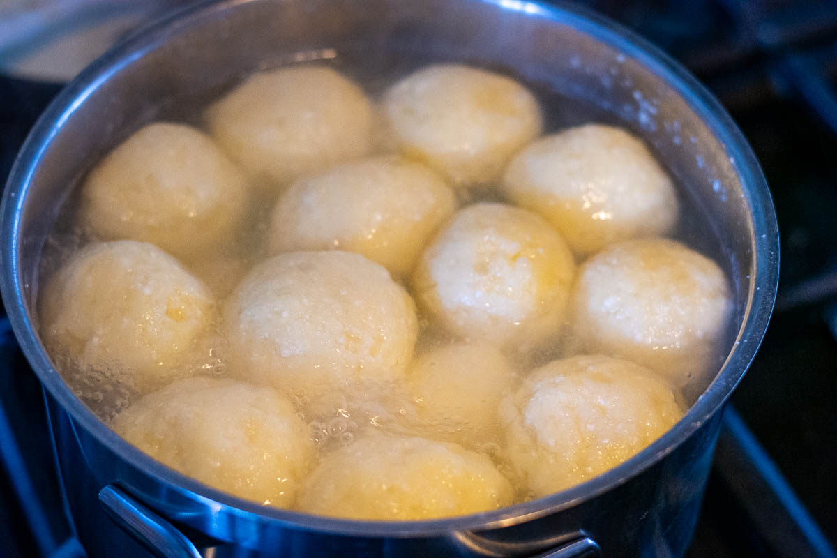 Potato dumplings floating in boiling water.