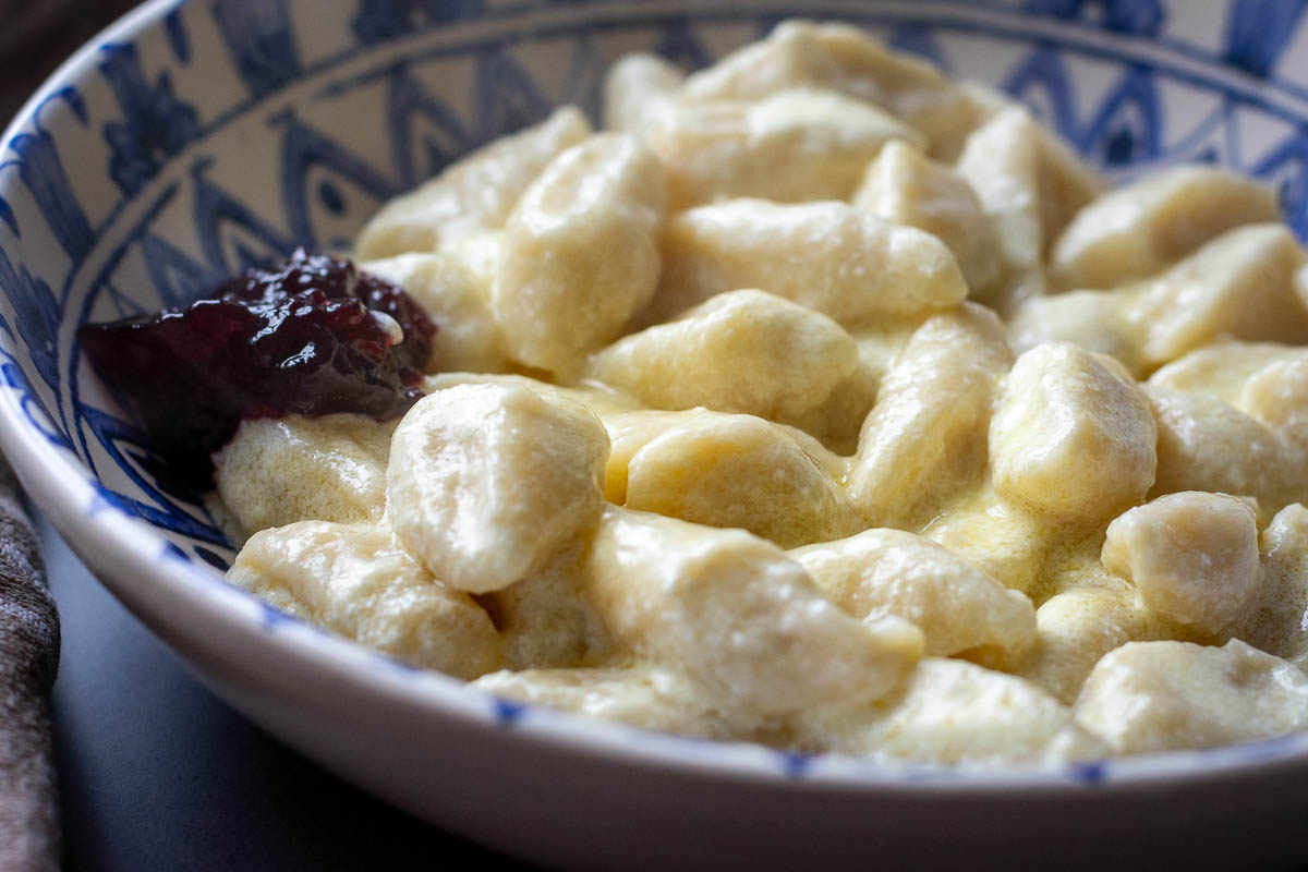 Lithuanian Farmers Cheese Dumplings in a white and blue bowl.
