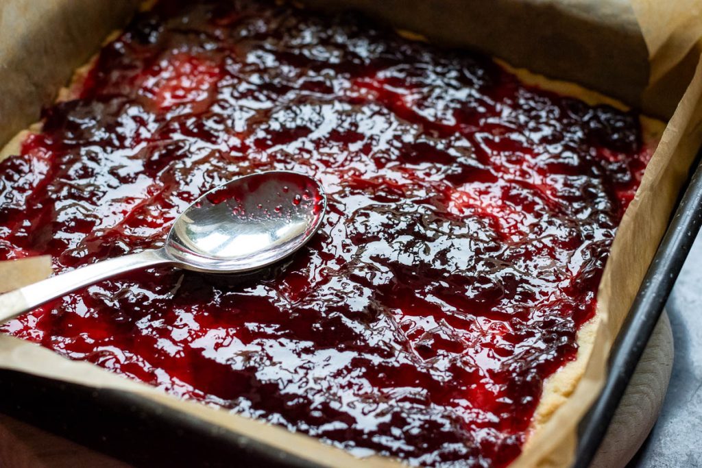 Jam spread on the pastry base with the back of a spoon.