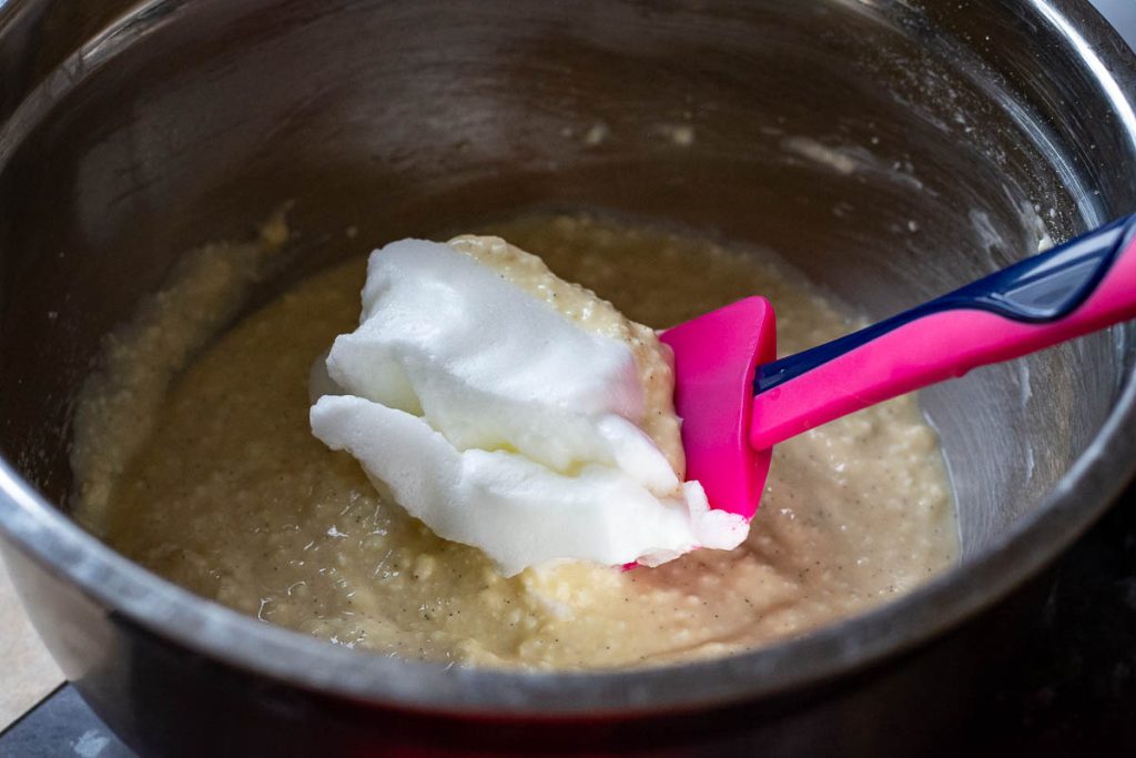 Mixing in the egg whites into farmers cheese filling for the Lithuanian cake.