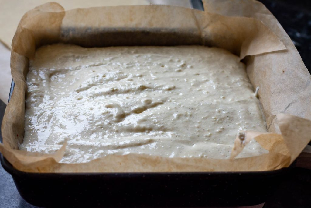 Farmers cheese filling on to pog jam and pastry base.