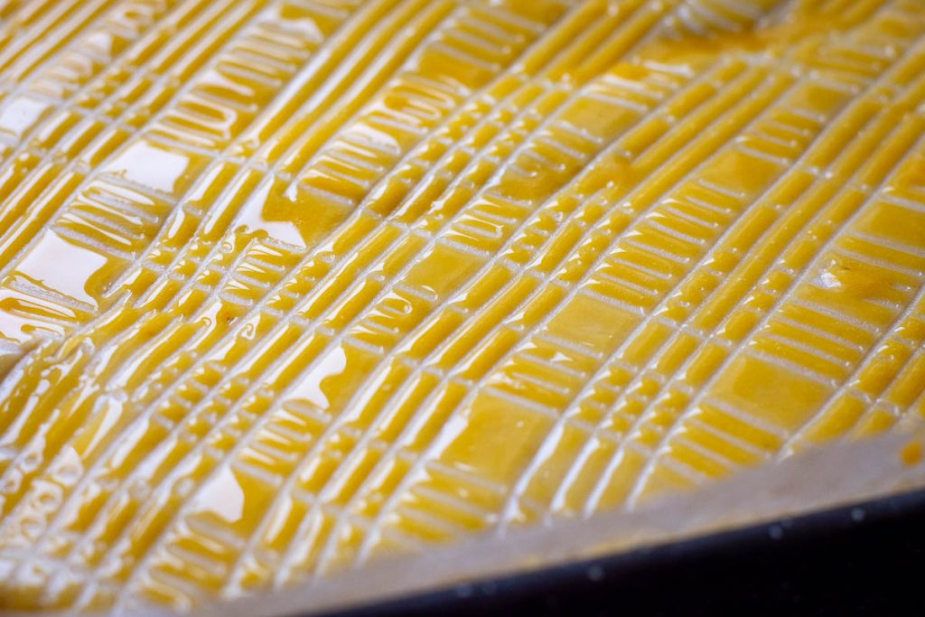 Pattern of the top of the Lithuanian cake created in the egg yolk wash.