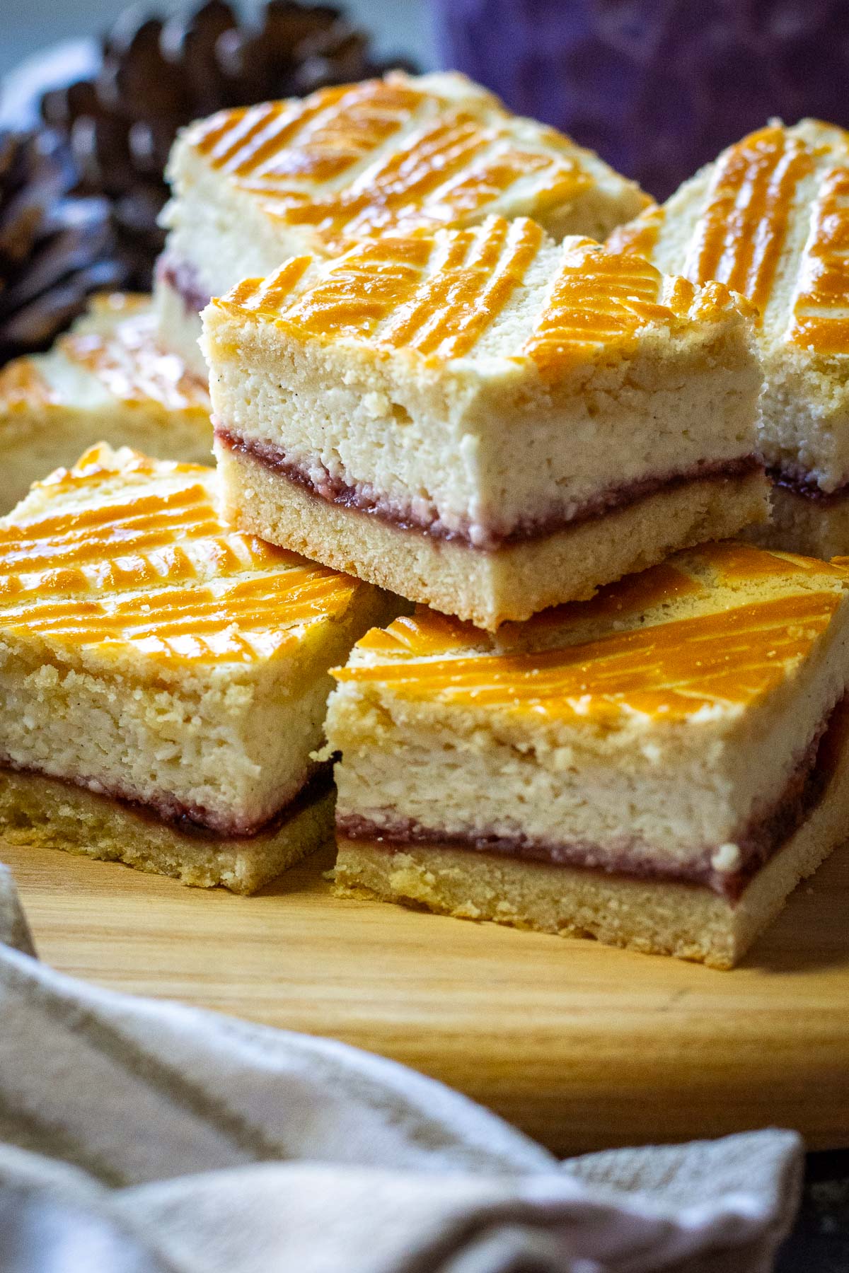 Squares of Lithuanian Farmers cheese cake on a wooden board.