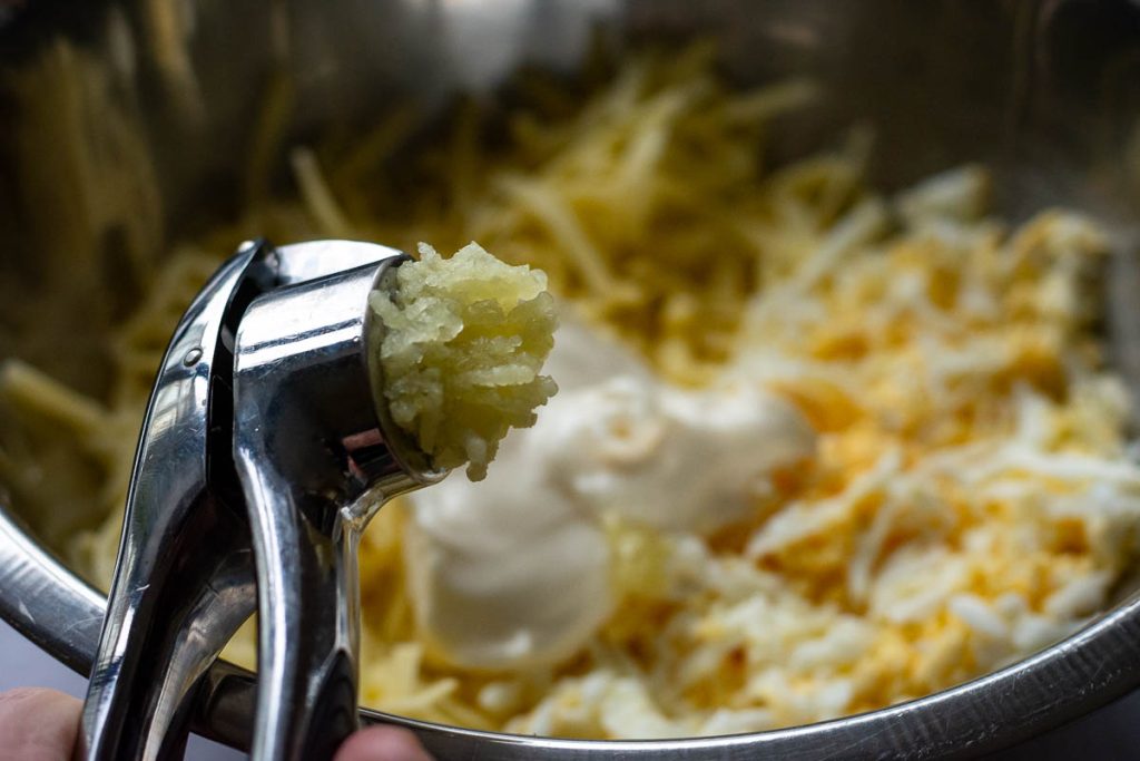 Garlic coming out of a garlic pres.