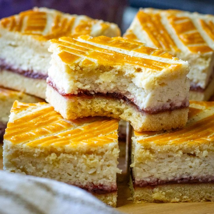 Lithuanian Farmers Cheese Cake cut into squares with one bike missing a bite.