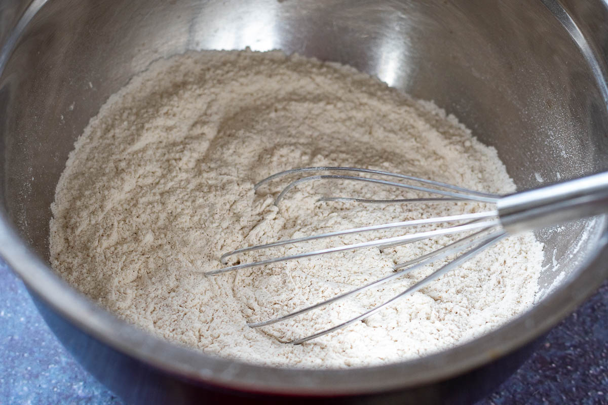 Dry ingredients mixed in a large metal bowl. 
