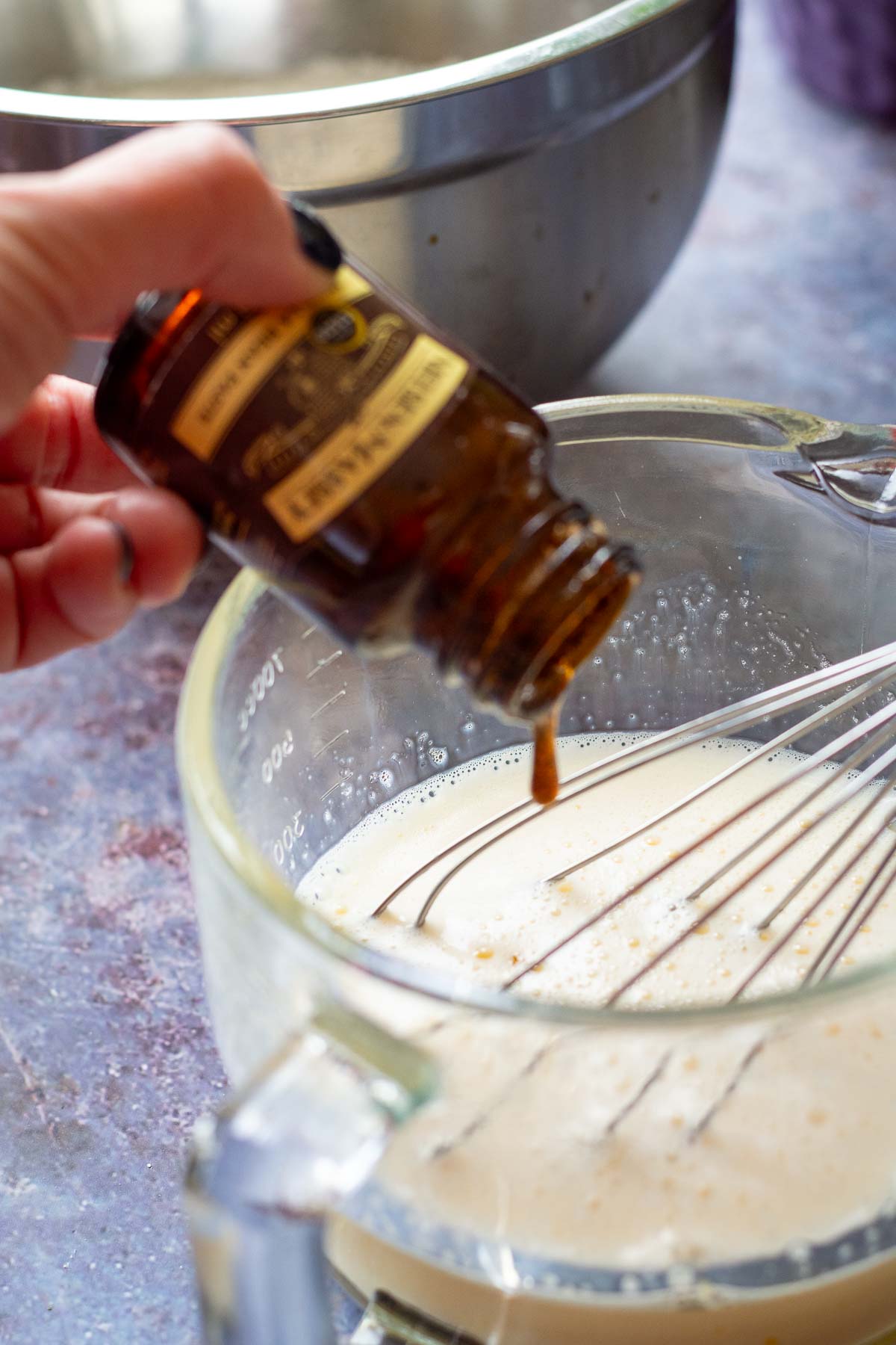Vanilla bean paste being added to the wet ingredients for the  Lithuanian pancakes. 