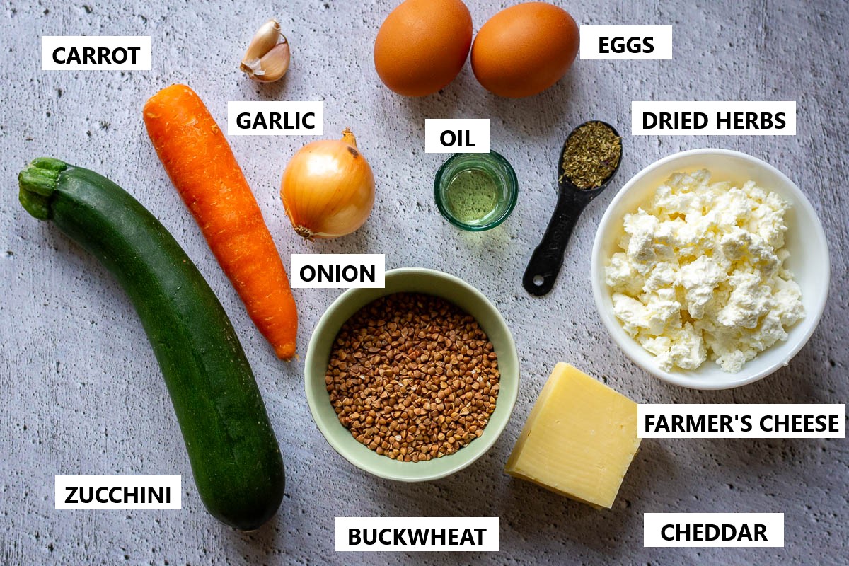 Ingredients for Lithuanian Buckwheat casserole on a light grey surface.