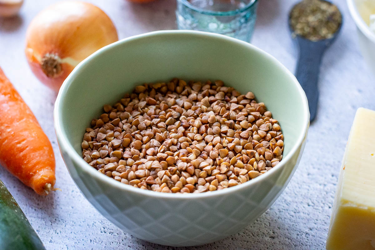 Roasted buckwheat goats known as kasha, in a small green bowl.