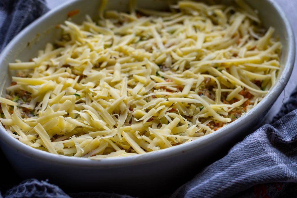 Grated cheese o top of the Lithuanian buckwheat bake.