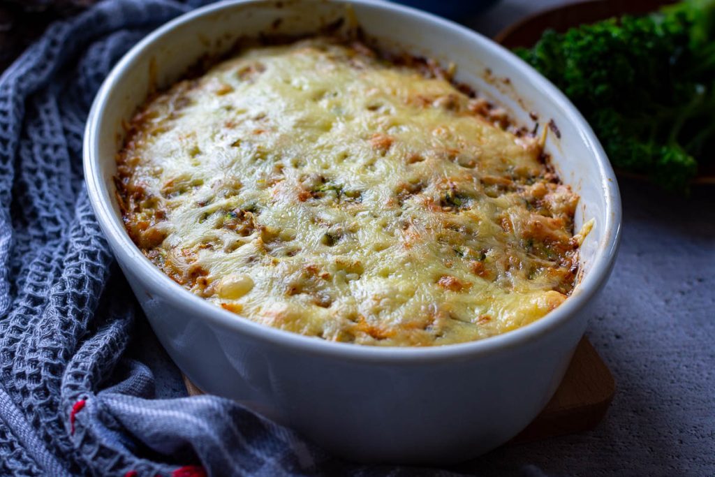 Baked Buckwheat casserole served on the table next to a grey kitchen towel.