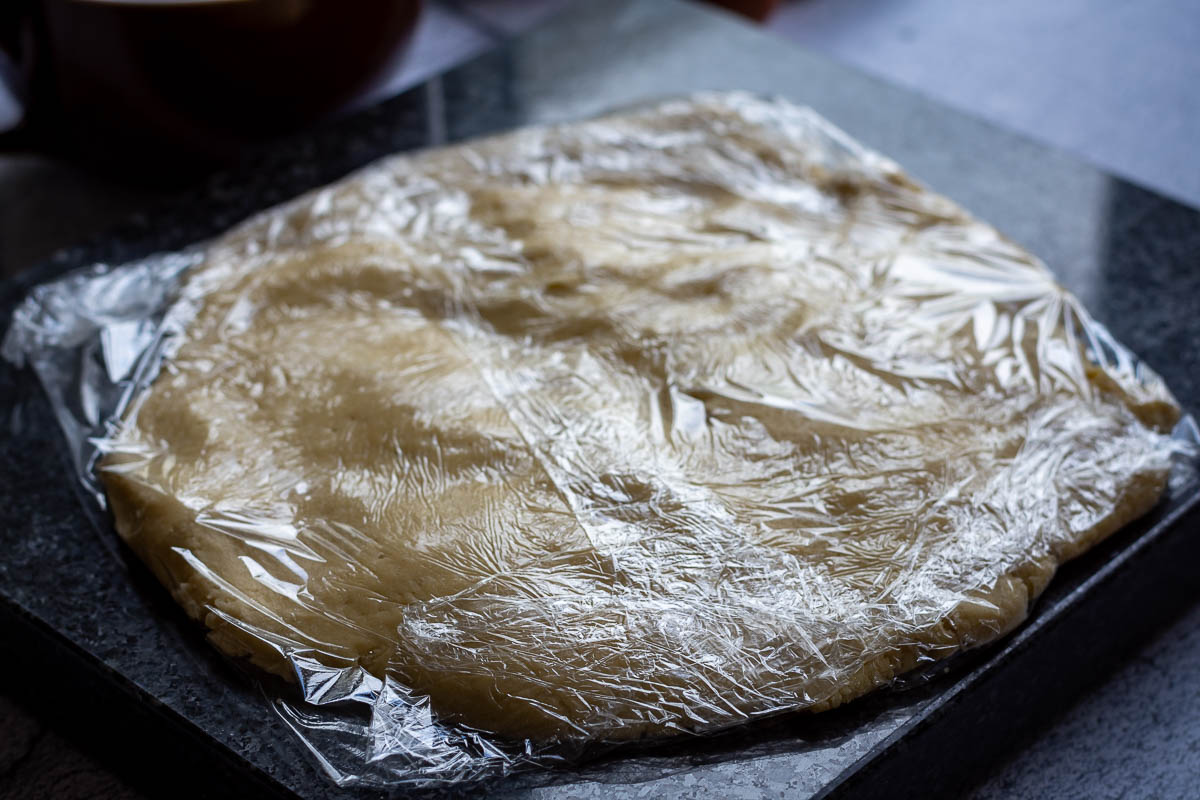Sour cream pastry dough wrapped in plastic wrap.