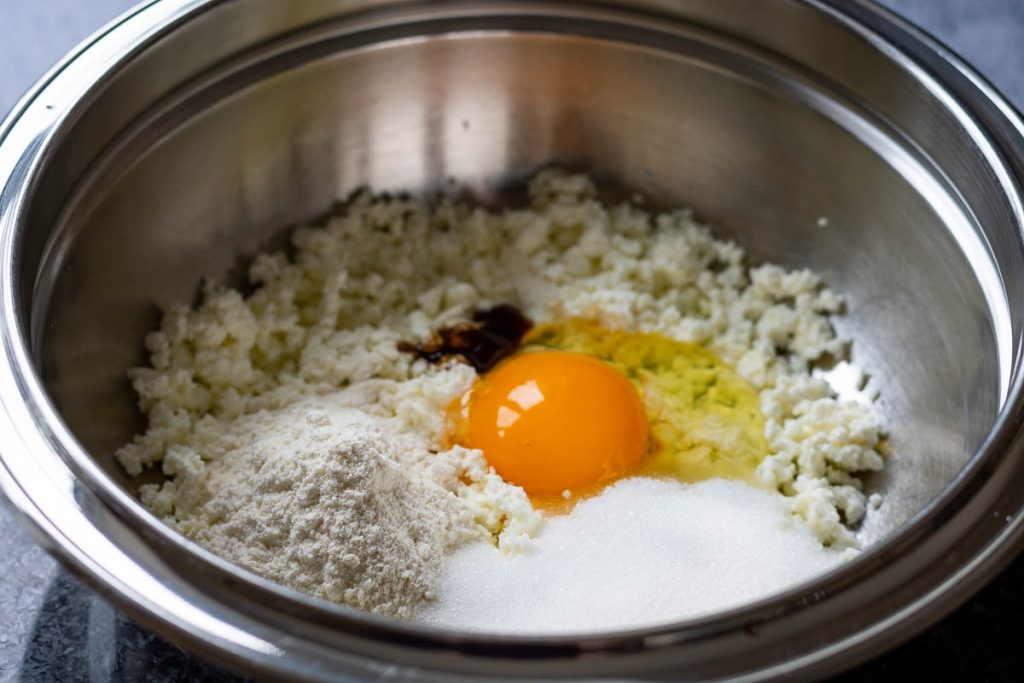 All farmers cheese filling ingredients in a metal bowl.