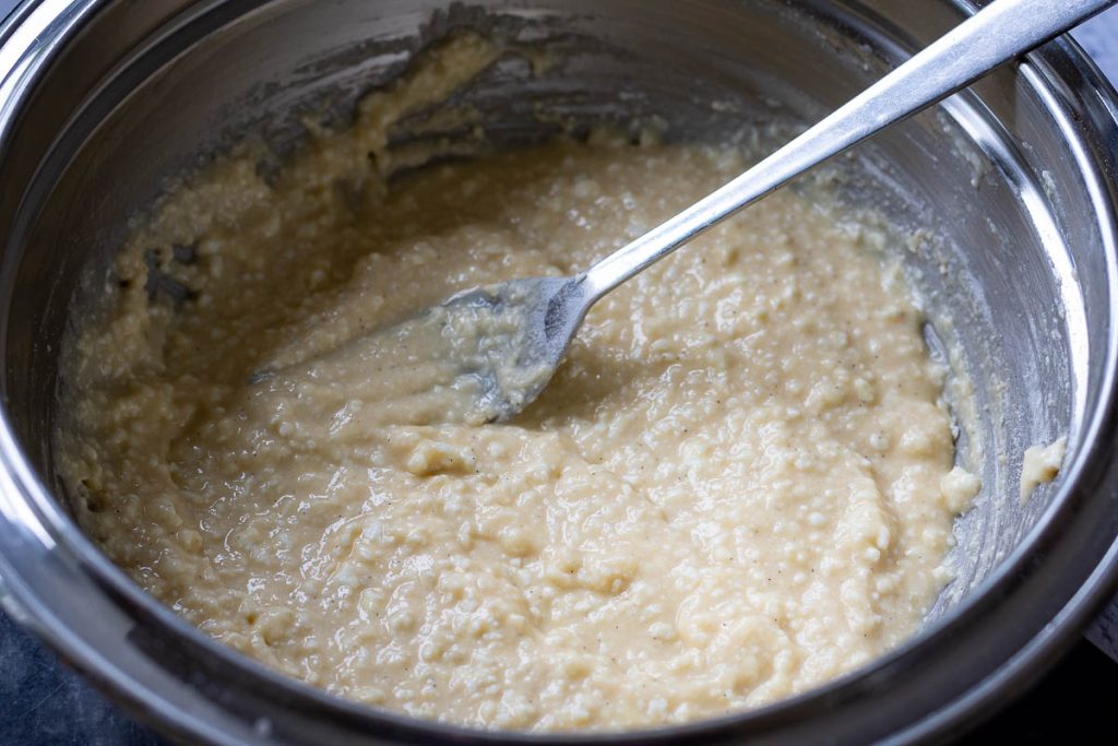Farmers cheese filling ready in a metal mixing bowl.