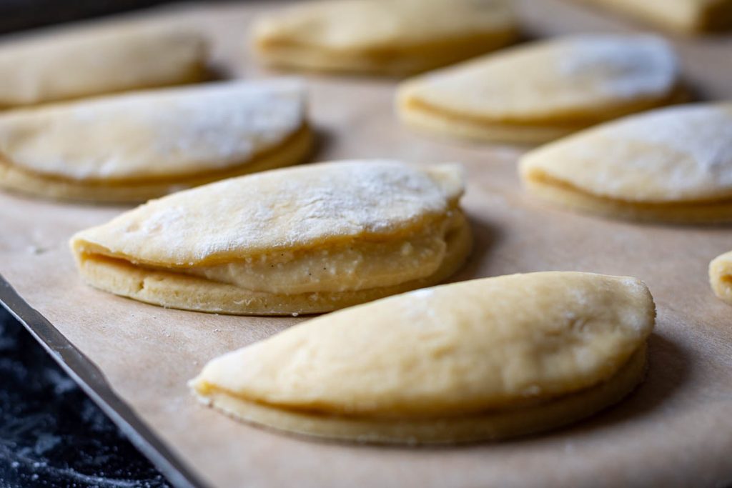 Lithuanian Grietinieciai assembled on a baking sheet lined with parchment paper.