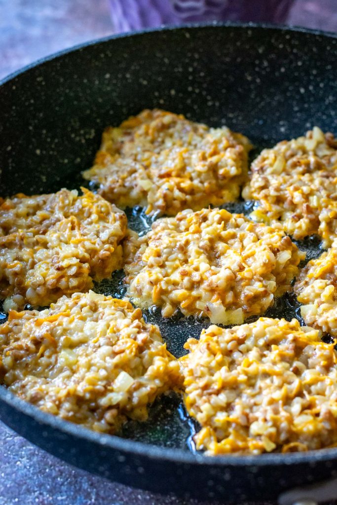 Buckwheat fritters in a large frying pan. 