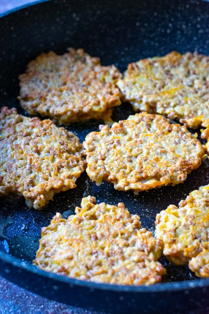 Lithuanian buckwheat fritters with crispy edges in a frying pan. 