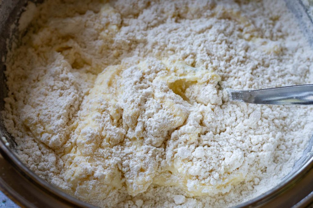 Adding flour to the wet ingredients.