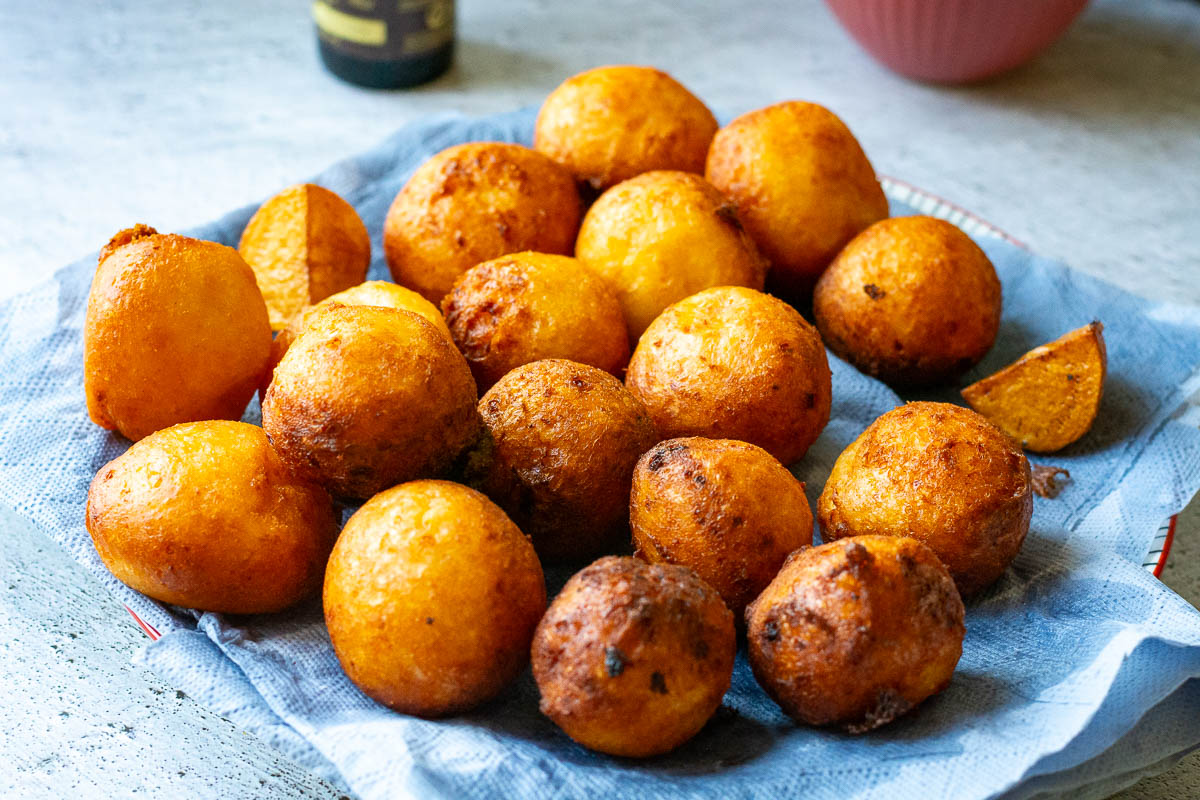 Lithuanian Farmers Cheese doughnuts on a plate with paper towel.
