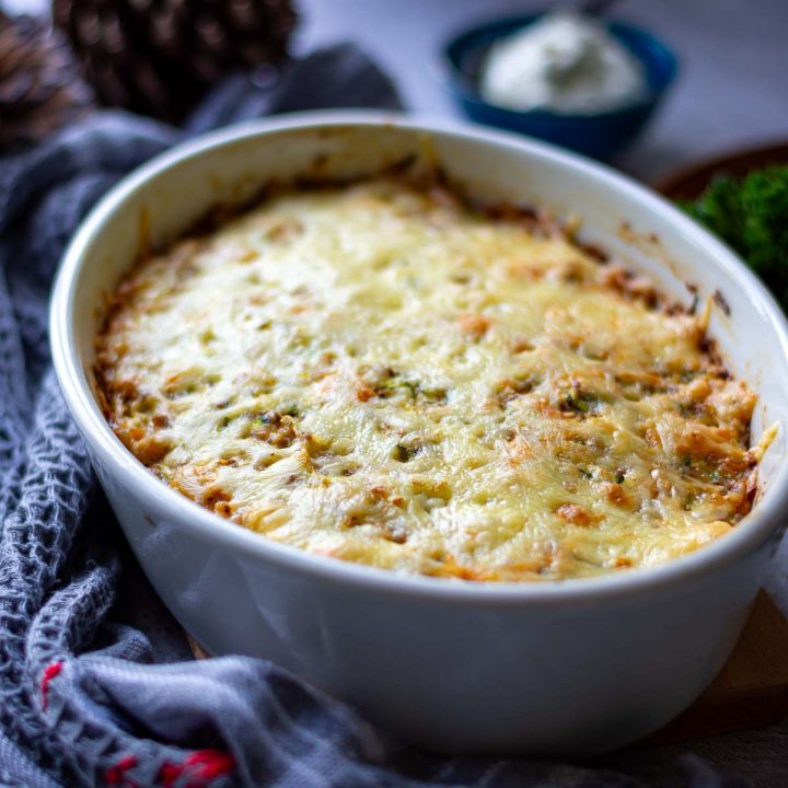 Cheesy buckwheat casserole in a white ovenproof dish.
