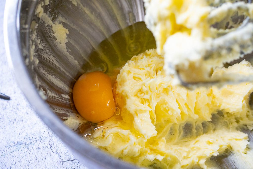 Beaten butter and sugar with the egg cracked into the bowl.