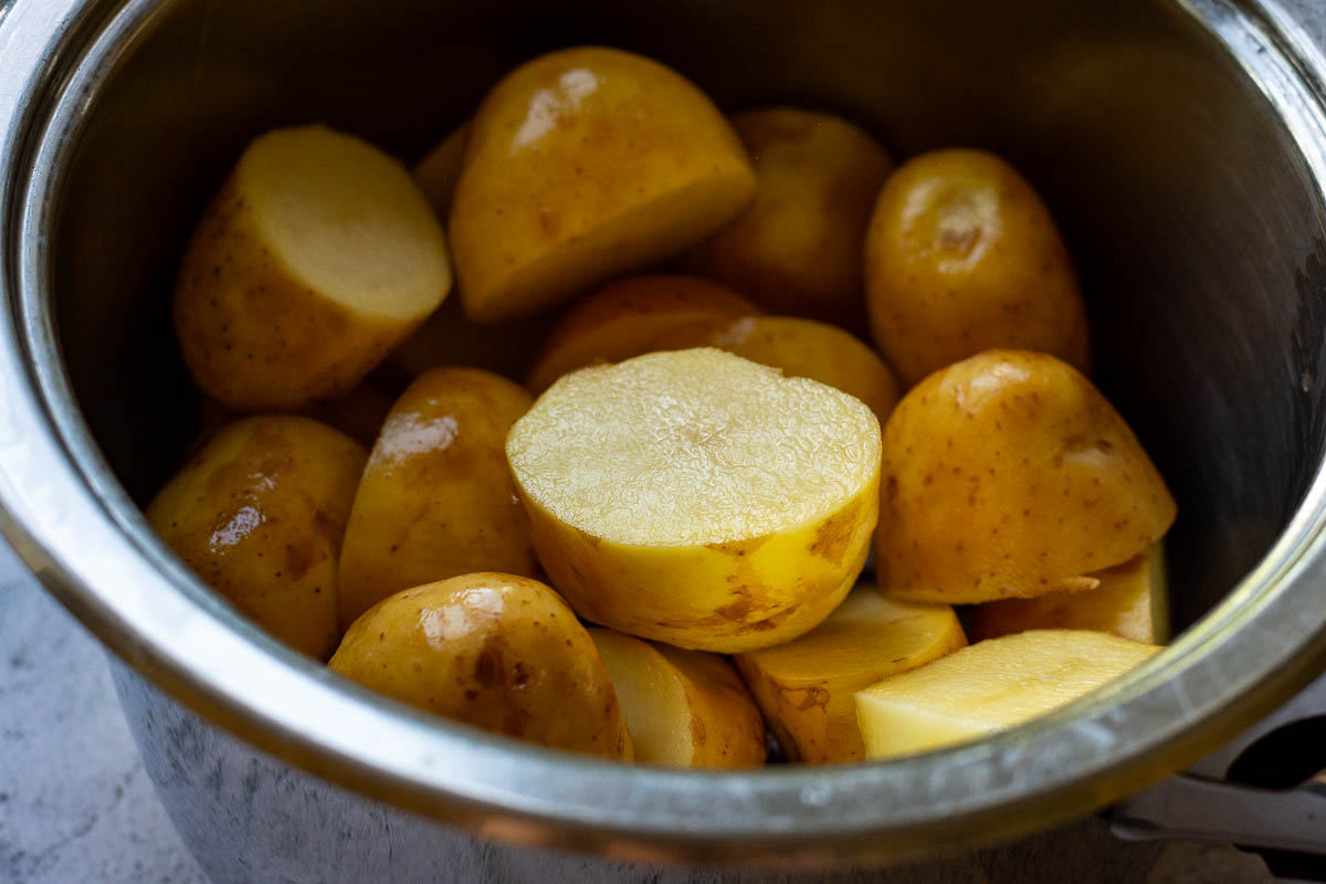 Unpeeled Lithuanian potatoes in a saucepan.