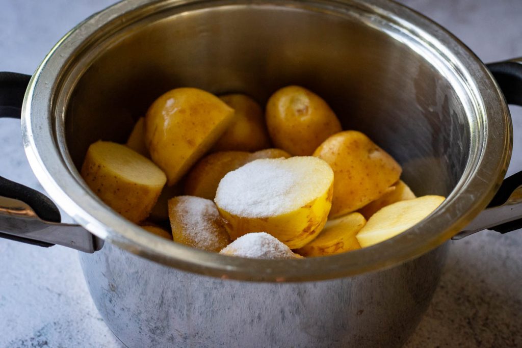 Raw put potatoes in a saucepan.