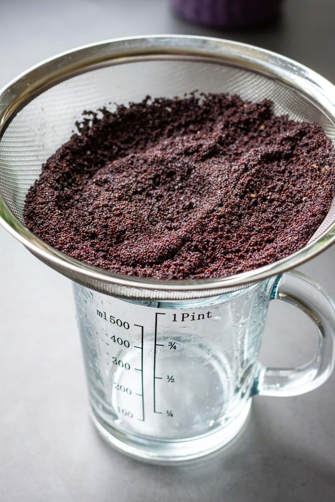 Draining the poppy seeds after soaking them overnight. 
