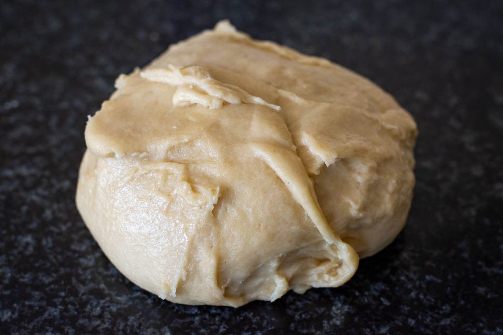 The dough ona dark kitchen worktop. 