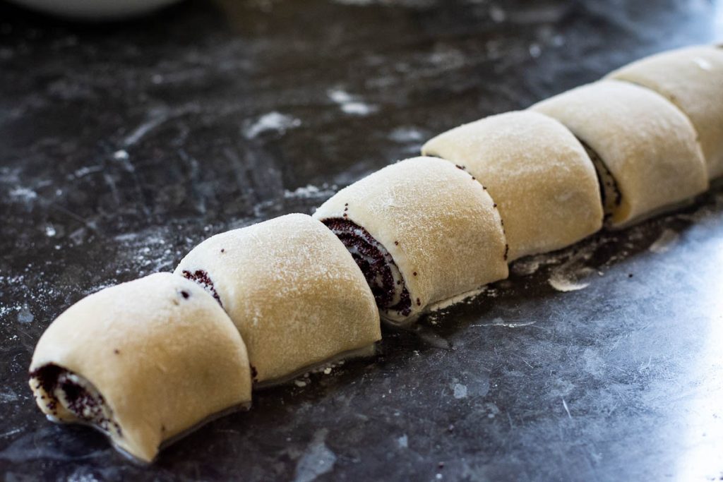 Rolled dough with poppy seed filling cut into 8 even pieces. 