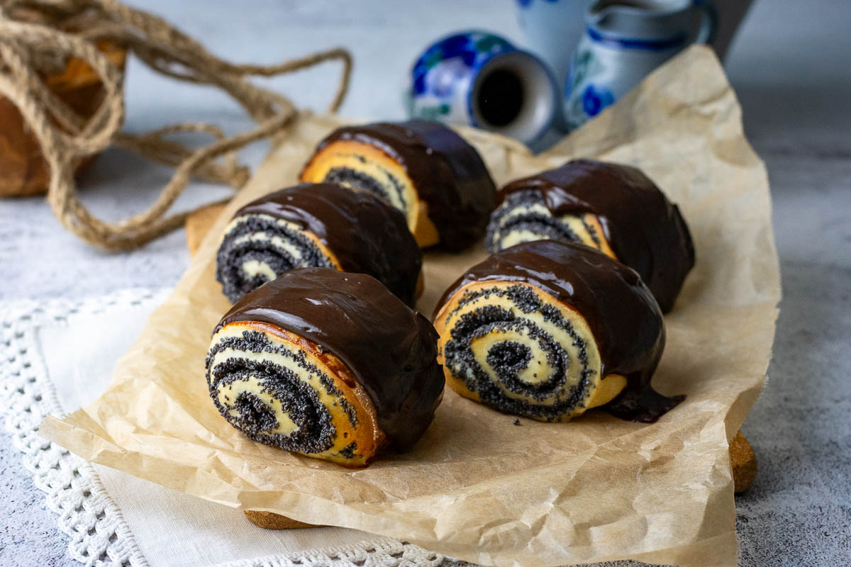 Lithuanian Poppy Seed Rolls on a sheet of brown parchment paper. 