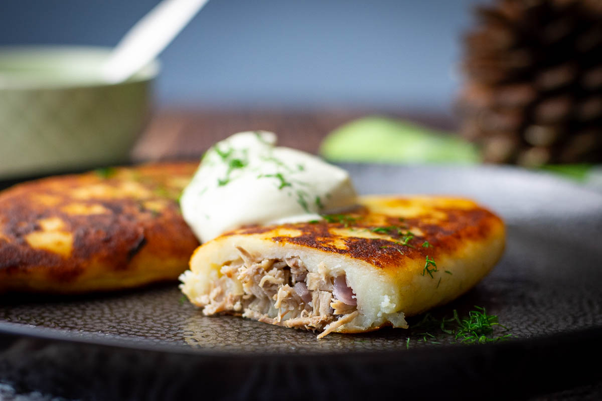 Samogitian pancake cut into exposing the meat filling.