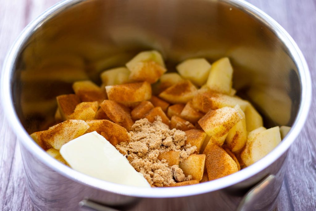 Apples, sugar, butter and cinnamon in a large pan.