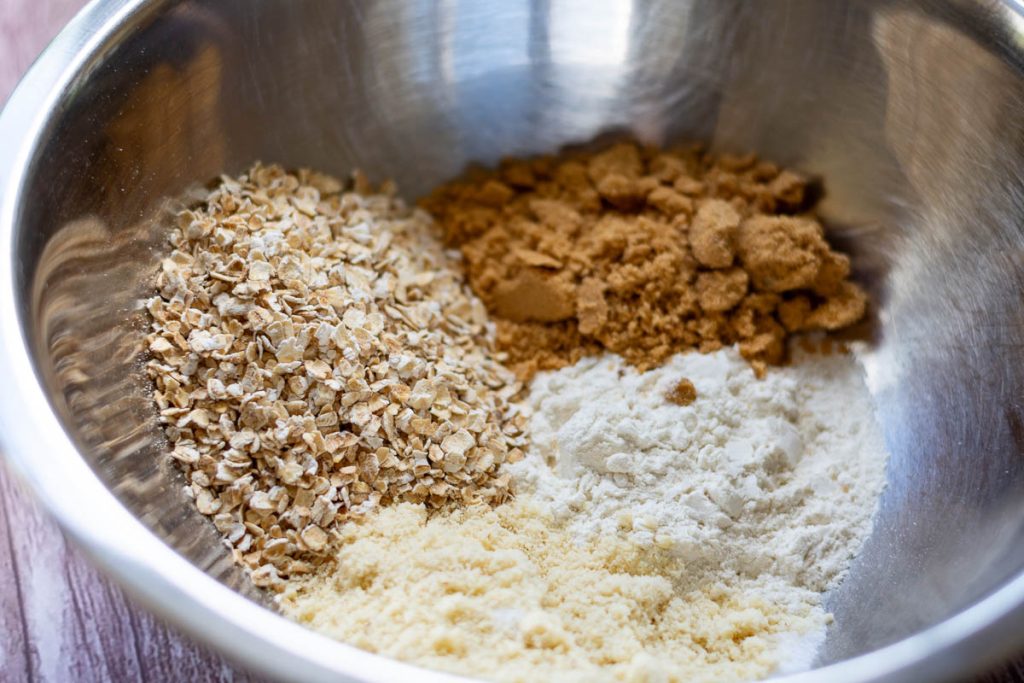 All dry ingredients for crumble topping in a metal bowl.